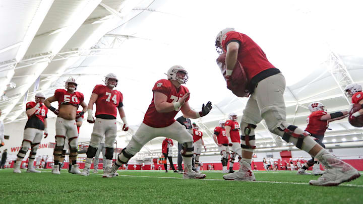 The Wisconsin Badgers offensive line runs drills during a spring football practice at Camp Randall Stadium in Madison The Wisconsin Badgers offensive line runs drills during a spring football practice at Camp Randall Stadium in Madison