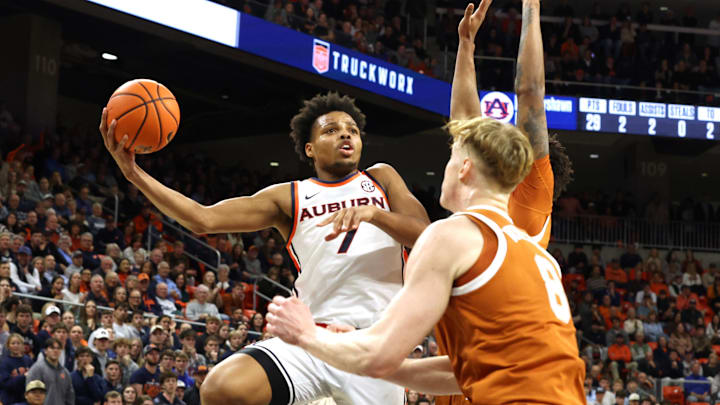 Jan 28, 2026; Auburn, Alabama, USA;  Auburn Tigers guard Keyshawn Hall (7) goes up for a shot against Texas Longhorns center Matas Vokietaitis (8) during the second half at Neville Arena. Mandatory Credit: John Reed-Imagn Images