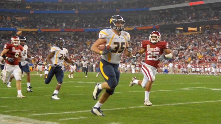 Jan 2, 2008; Glendale, AZ, USA; West Virginia Mountaineers running back Owen Schmitt (35) runs the ball for a second quarter touchdown against the Oklahoma Sooners during the Fiesta Bowl at University of Phoenix Stadium. Mandatory Credit: Mark J. Rebilas-Imagn Images Jan 2, 2008; Glendale, AZ, USA; West Virginia Mountaineers running back Owen Schmitt (35) runs the ball for a second quarter touchdown against the Oklahoma Sooners during the Fiesta Bowl at University of Phoenix Stadium. Mandatory Credit: Mark J. Rebilas-Imagn Images