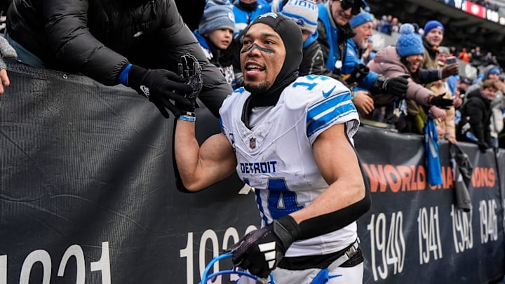 Detroit Lions wide receiver Amon-Ra St. Brown (14) high-fives fans celebrates 34-17 win over Chicago Bears as he exits the field at Soldier Field in Chicago, Ill. on Sunday, Dec. 22, 2024.