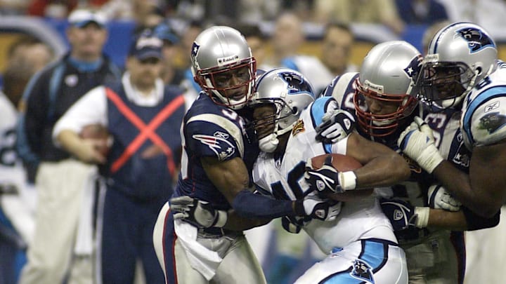 Feb 1, 2004; Houston, TX, USA; FILE PHOTO;  New England Patriots defensive back Tyrone Poole (38) and Richard Seymour (93) tackles Carolina Panthers running back Stephen Davis (48) as guard Jeno James (78) tries to block during Super Bowl XXXVIII at Reliant Stadium. The Patriots defeated the Panthers 32-29. Mandatory Credit: MPS-Imagn Images