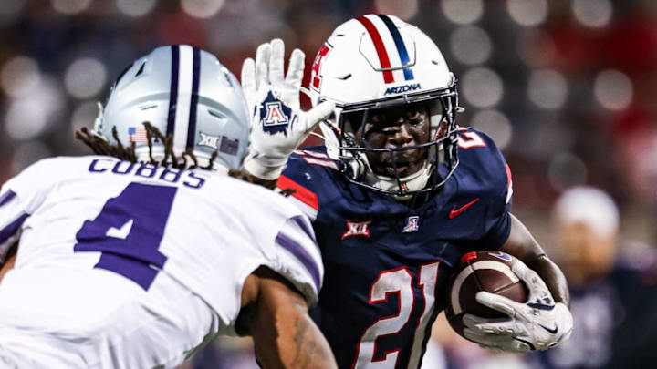 Sep 12, 2025; Tucson, Arizona, USA; Arizona Wildcats running back Ismail Mahdi (21) runs the ball while Kansas State Wildcats safety Daniel Cobbs (4) defends during the fourth quarter at Arizona Stadium. Mandatory Credit: Aryanna Frank-Imagn Images Sep 12, 2025; Tucson, Arizona, USA; Arizona Wildcats running back Ismail Mahdi (21) runs the ball while Kansas State Wildcats safety Daniel Cobbs (4) defends during the fourth quarter at Arizona Stadium. Mandatory Credit: Aryanna Frank-Imagn Images