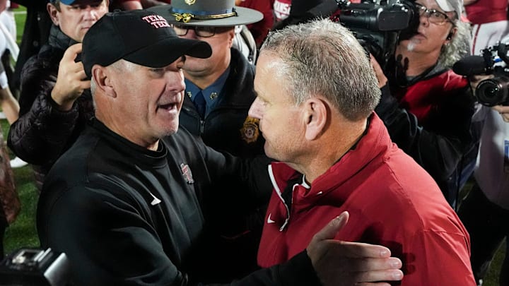 Texas Tech coach Joey McGuire and Arkansas coach Sam Pittman embrace after Arkansas defeated Texas Tech, 36-26, in the AutoZone Liberty Bowl in Memphis, Tenn., on Friday, December 27, 2024.