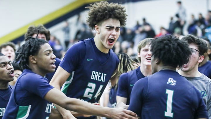 Great Crossing's Malachi Moreno (24) and teammates mob Vince Dawson (1) in jubilation after Dawson's last second shot lifted the Warhawks 48-46 over Newport at Thursday's 2023 Chad Gardner Law King of the Bluegrass holiday basketball tournament at Fairdale High School. Dec. 21, 2023 Great Crossing's Malachi Moreno (24) and teammates mob Vince Dawson (1) in jubilation after Dawson's last second shot lifted the Warhawks 48-46 over Newport at Thursday's 2023 Chad Gardner Law King of the Bluegrass holiday basketball tournament at Fairdale High School. Dec. 21, 2023