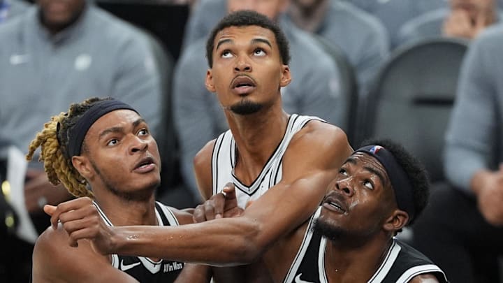 Oct 26, 2025; San Antonio, Texas, USA; Brooklyn Nets forward Noah Clowney (21) and center Day'Ron Sharpe (20) push San Antonio Spurs forward Victor Wembanyama (1) back in the second half at Frost Bank Center. Mandatory Credit: Daniel Dunn-Imagn Images