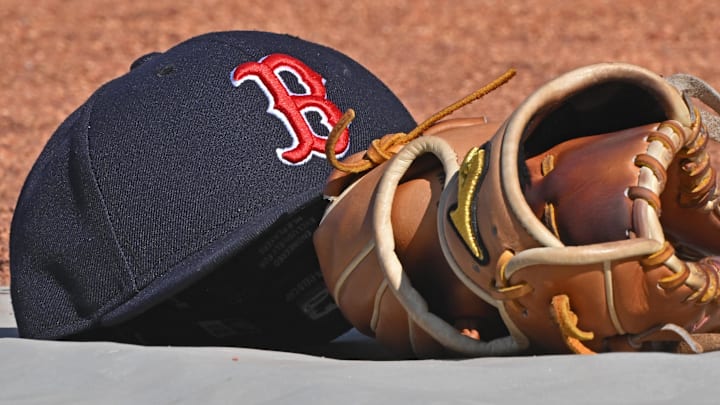 May 10, 2025; Kansas City, Missouri, USA;  A general view of a Boston Red Sox's cap and glove on the field before a game against the Kansas City Royals at Kauffman Stadium. Mandatory Credit: Peter Aiken-Imagn Images