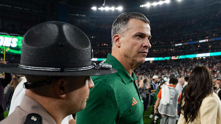 Miami Hurricanes head coach Mario Cristobal walks across the field after winning the CFP Fiesta Bowl against Ole Miss at the State Farm Stadium, in Glendale, Ariz., on Thursday, Jan. 8, 2026.