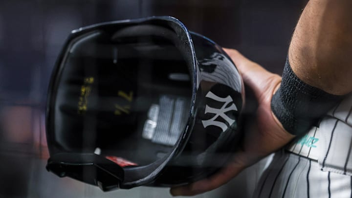 Aug 13, 2025; Bronx, New York, USA; A view of a battling helmet held by New York Yankees left fielder Jasson Dominguez (24) during the ninth inning against the Minnesota Twins  at Yankee Stadium. Mandatory Credit: Vincent Carchietta-Imagn Images