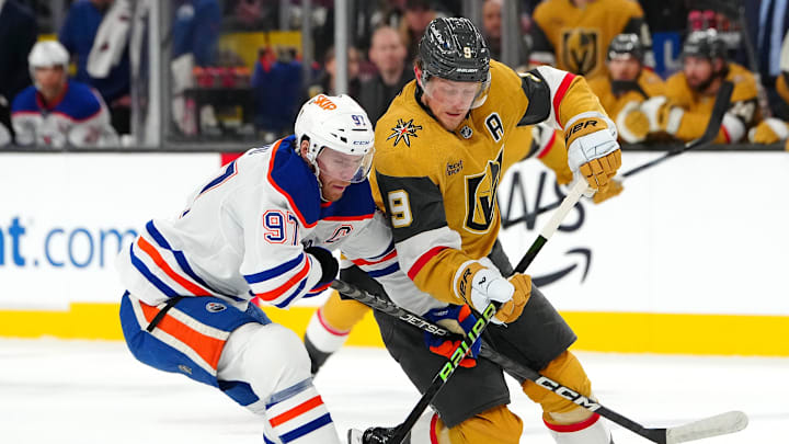 Dec 3, 2024; Las Vegas, Nevada, USA; Edmonton Oilers center Connor McDavid (97) defends against Vegas Golden Knights center Jack Eichel (9) during the second period at T-Mobile Arena. Mandatory Credit: Stephen R. Sylvanie-Imagn Images