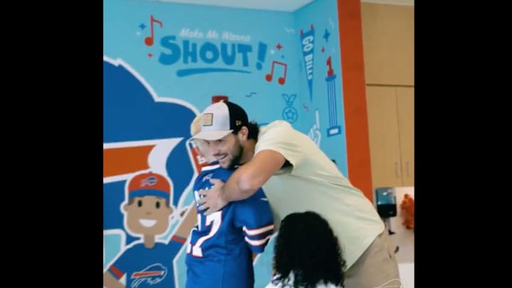Allen hugs a patient from Oishei Children's Hospital in Buffalo.