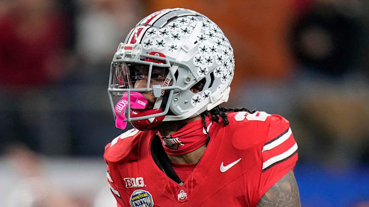 Ohio State Buckeyes wide receiver Emeka Egbuka (2) celebrates after making a catch against Texas Longhorns defensive back Jaylon Guilbeau (3) and linebacker Anthony Hill Jr. (0) in the first quarter of the Cotton Bowl Classic during the College Football Playoff semifinal game at AT&T Stadium in Arlington, Texas on January, 10, 2025.