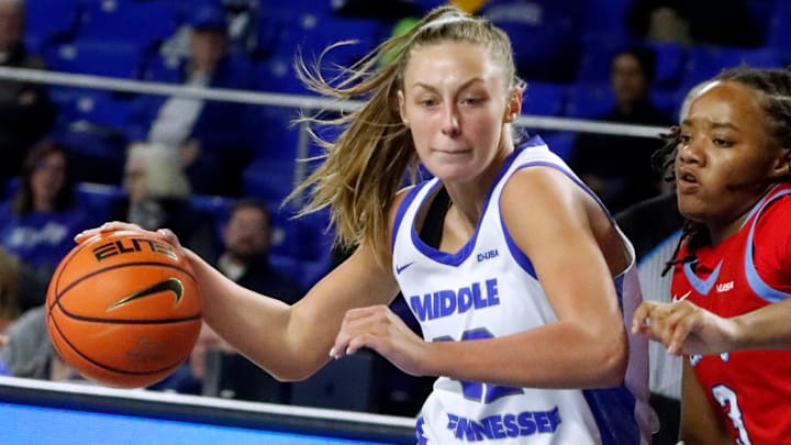 Middle Tennessee State guard MacIe Phifer (22) drives to the basket as Liberty guard Jakayla Thompson (3) guards her during the Women's NCAA basketball game on Friday, Jan. 23, 2026.