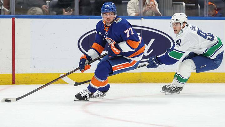 Oct 13, 2026; Elmont, New York, USA; New York Islanders defenseman Tony DeAngelo (77) and Vancouver Canucks left wing Liam Ohgren (92) battle for control of the puck in the first period at UBS Arena. Mandatory Credit: Wendell Cruz-Imagn Images Oct 13, 2026; Elmont, New York, USA; New York Islanders defenseman Tony DeAngelo (77) and Vancouver Canucks left wing Liam Ohgren (92) battle for control of the puck in the first period at UBS Arena. Mandatory Credit: Wendell Cruz-Imagn Images