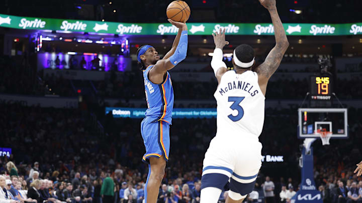 Dec 31, 2024; Oklahoma City, Oklahoma, USA; Oklahoma City Thunder guard Shai Gilgeous-Alexander (2) shoots as Minnesota Timberwolves forward Jaden McDaniels (3) defends during the second half at Paycom Center. Mandatory Credit: Alonzo Adams-Imagn Images Dec 31, 2024; Oklahoma City, Oklahoma, USA; Oklahoma City Thunder guard Shai Gilgeous-Alexander (2) shoots as Minnesota Timberwolves forward Jaden McDaniels (3) defends during the second half at Paycom Center. Mandatory Credit: Alonzo Adams-Imagn Images