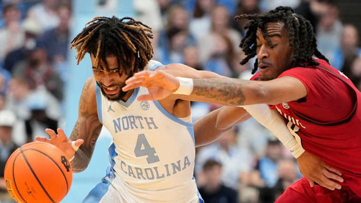 Feb 19, 2025; Chapel Hill, North Carolina, USA; North Carolina Tar Heels guard RJ Davis (4) dribbles as North Carolina State Wolfpack guard Jayden Taylor (8) defends in the second half at Dean E. Smith Center. Mandatory Credit: Bob Donnan-Imagn Images Feb 19, 2025; Chapel Hill, North Carolina, USA; North Carolina Tar Heels guard RJ Davis (4) dribbles as North Carolina State Wolfpack guard Jayden Taylor (8) defends in the second half at Dean E. Smith Center. Mandatory Credit: Bob Donnan-Imagn Images