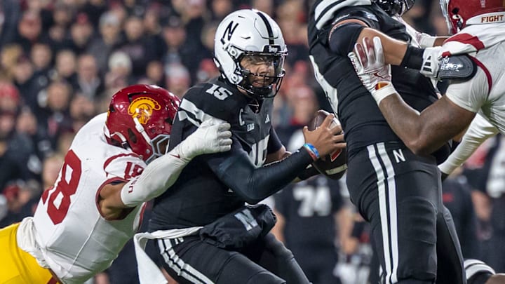 Nebraska quarterback Dylan Raiola attempts to evade the USC rush. He was injured on the play and did not return to the game.
