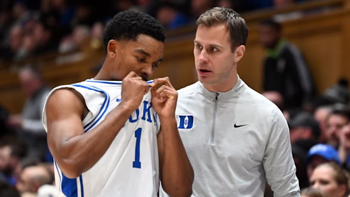 Dec 16, 2025; Durham, North Carolina, USA; Duke Blue Devils head coach Jon Scheyer (right) talks to guard Caleb Foster during the second half against the Lipscomb Bisons at Cameron Indoor Stadium. The Blue Devils won 97-73. Mandatory Credit: Rob Kinnan-Imagn Images Dec 16, 2025; Durham, North Carolina, USA; Duke Blue Devils head coach Jon Scheyer (right) talks to guard Caleb Foster during the second half against the Lipscomb Bisons at Cameron Indoor Stadium. The Blue Devils won 97-73. Mandatory Credit: Rob Kinnan-Imagn Images