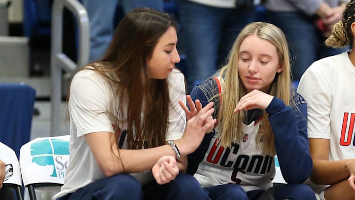UConn women's basketball teammates Paige Bueckers and Caroline Ducharme sit on the sideline during a game against the Tennessee Vols. UConn women's basketball teammates Paige Bueckers and Caroline Ducharme sit on the sideline during a game against the Tennessee Vols.