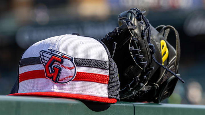 Jul 8, 2024; Detroit, Michigan, USA; A Cleveland Guardians baseball cap and glove sit on the dugout rail before the game against the Detroit Tigers at Comerica Park. Mandatory Credit: David Reginek-Imagn Images Jul 8, 2024; Detroit, Michigan, USA; A Cleveland Guardians baseball cap and glove sit on the dugout rail before the game against the Detroit Tigers at Comerica Park. Mandatory Credit: David Reginek-Imagn Images