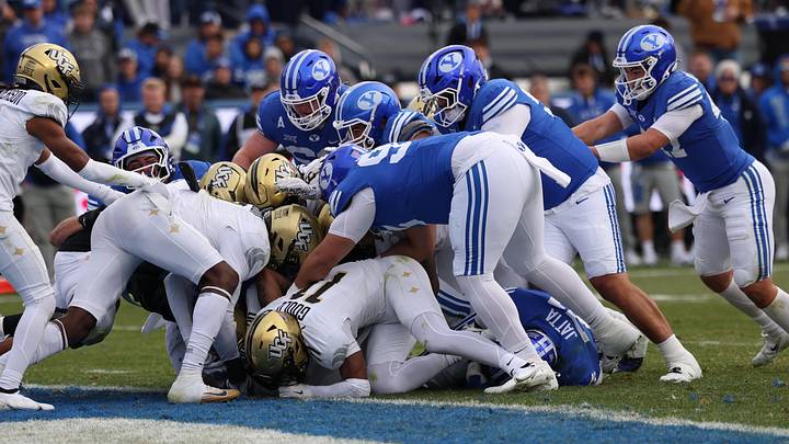 Nov 29, 2025; Provo, Utah, USA; The BYU Cougars offensive line pushes running back LJ Martin (4) into the end zone for a score against the UCF Knights during the second half at LaVell Edwards Stadium. Mandatory Credit: Rob Gray-Imagn Images