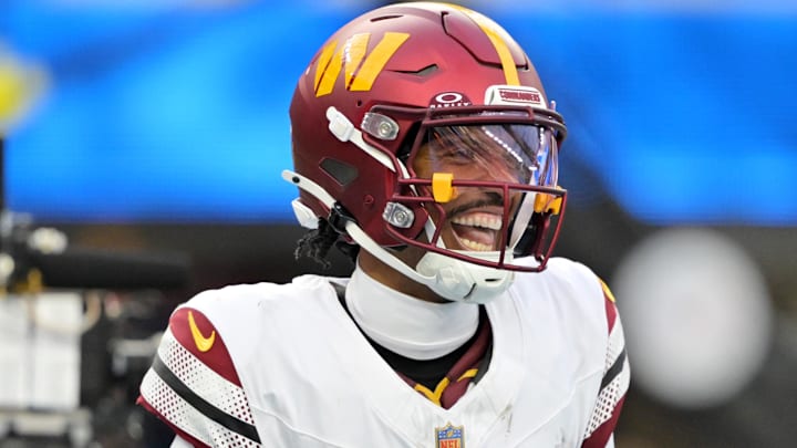 Oct 5, 2025; Inglewood, California, USA; Washington Commanders quarterback Jayden Daniels (5) celebrates after a touchdown against the Los Angeles Chargers in the second half at SoFi Stadium. Mandatory Credit: Jayne Kamin-Oncea-Imagn Images