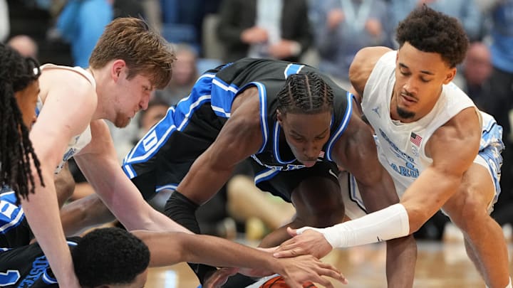 Feb 7, 2026; Chapel Hill, North Carolina, USA; Duke Blue Devils forward Maliq Brown (6) and guards Caleb Foster (1) and Dame Sarr (7) and North Carolina Tar Heels center Henri Veesaar (13) and guard Seth Trimble (7) fight for the ball in the second half at Dean E. Smith Center. Mandatory Credit: Bob Donnan-Imagn Images