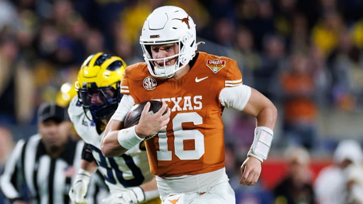 Texas Longhorns quarterback Arch Manning (16) rushes with the ball for a touchdown against the Michigan Wolverines during the second half at Camping World Stadium.