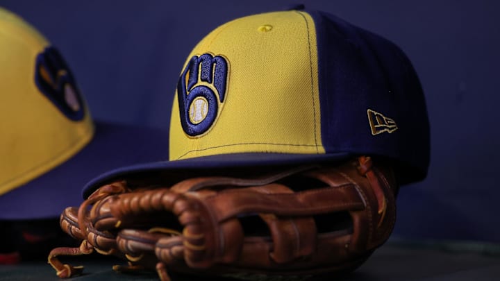 Jul 28, 2023; Atlanta, Georgia, USA; A detailed view of a Milwaukee Brewers hat and glove on the bench against the Atlanta Braves in the second inning at Truist Park. Mandatory Credit: Brett Davis-Imagn Images