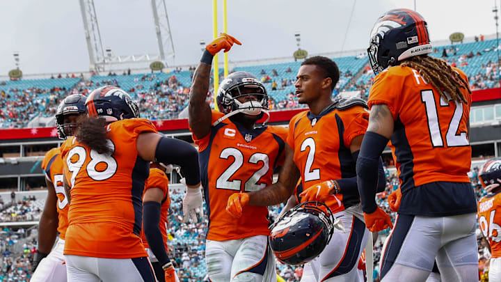 Sep 19, 2021; Jacksonville, Florida, USA;  Denver Broncos strong safety Kareem Jackson (22) celebrates after a reception by cornerback Pat Surtain II (2) in the fourth quarter against the Jacksonville Jaguars at TIAA Bank Field. Mandatory Credit: Nathan Ray Seebeck-Imagn Images