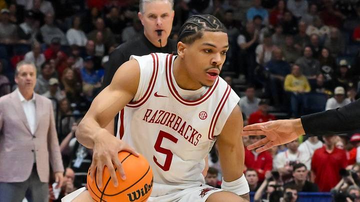 Mar 15, 2026; Nashville, TN, USA; Arkansas Razorbacks guard Darius Acuff Jr. (5) drives to the basket past Vanderbilt Commodores forward Devin McGlockton (99) during the first half during the men's SEC Conference Tournament Championship at Bridgestone Arena. Mandatory Credit: Steve Roberts-Imagn Images