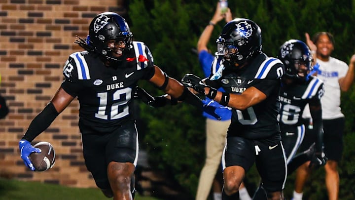 Sep 28, 2024; Durham, North Carolina, USA;  Duke Blue Devils linebacker Tre Freeman (12) and cornerback Chandler Rivers (0) run the field and celebrates with fans during the second half of the game against North Carolina Tar Heels at Wallace Wade Stadium. Mandatory Credit: Jaylynn Nash-Imagn Images