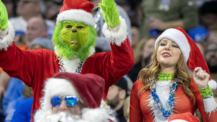 Detroit Lions fans dressed in Christmas attire react in the first half against the Denver Broncos at Ford Field