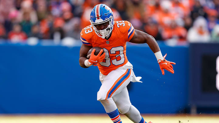 Jan 5, 2025; Denver, Colorado, USA; Denver Broncos running back Javonte Williams (33) runs the ball in the second quarter against the Kansas City Chiefs at Empower Field at Mile High. 
