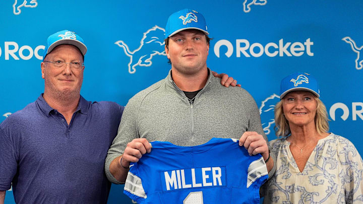 Detroit Lions first round draft Blake Miller, center, poses for a photo with his father Chris Miller, left, and mother Karen Miller at his introductory press conference at Meijer Performance Center in Allen Park on Friday, April 24, 2026.