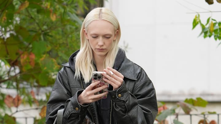 A woman on her phone in the streets of Paris A woman on her phone in the streets of Paris