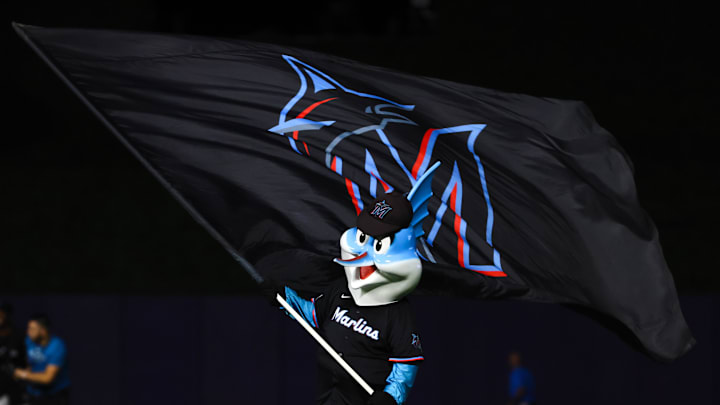 Jul 19, 2024; Miami, Florida, USA; Miami Marlins mascot Billy the Marlin celebrates with a team flag after the game against the New York Mets at loanDepot Park. Mandatory Credit: Sam Navarro-Imagn Images