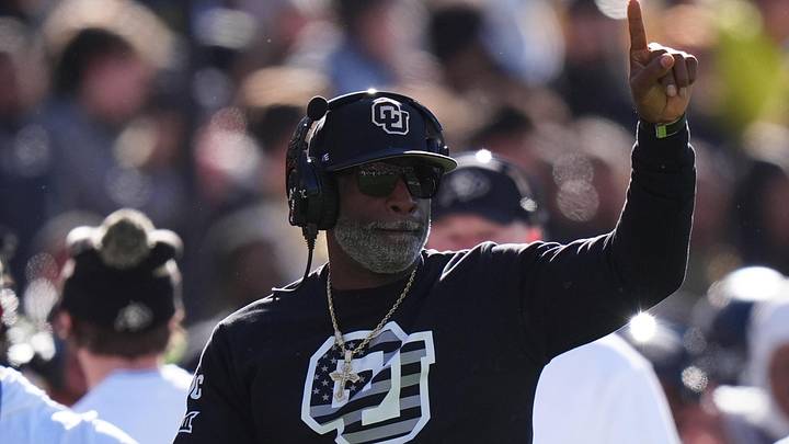 Nov 16, 2024; Boulder, Colorado, USA; Colorado Buffaloes head coach Deion Sanders calls in a play in the first quarter against the Utah Utes at Folsom Field. 
