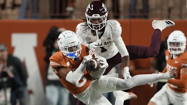 Texas Longhorns defensive back Kobe Black makes an interception on a pass intended for Texas A&M Aggies wide receiver Mario Craver during the second half at Darrell K Royal-Texas Memorial Stadium.
