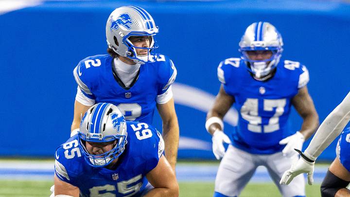 Detroit Lions quarterback Luke Altmyer (2) lines up behind center Seth McLaughlin (65) at Ford Field against Commanders Detroit Lions quarterback Luke Altmyer (2) lines up behind center Seth McLaughlin (65) at Ford Field against Commanders