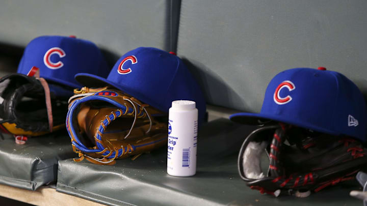 Apr 3, 2019; Atlanta, GA, USA; Detailed view of Chicago Cubs hats and gloves in the dugout against the Atlanta Braves in the fifth inning at SunTrust Park. Mandatory Credit: Brett Davis-Imagn Images
