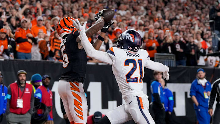 Cincinnati Bengals wide receiver Tee Higgins (5) catches a touchdown pass over Denver Broncos cornerback Riley Moss (21) in the fourth quarter of the NFL Week 17 game between the Cincinnati Bengals and the Denver Broncos at Paycor Stadium in downtown Cincinnati on Saturday, Dec. 28, 2024. The Bengals took a 30-24 win in overtime to remain in the post season chase. Cincinnati Bengals wide receiver Tee Higgins (5) catches a touchdown pass over Denver Broncos cornerback Riley Moss (21) in the fourth quarter of the NFL Week 17 game between the Cincinnati Bengals and the Denver Broncos at Paycor Stadium in downtown Cincinnati on Saturday, Dec. 28, 2024. The Bengals took a 30-24 win in overtime to remain in the post season chase.