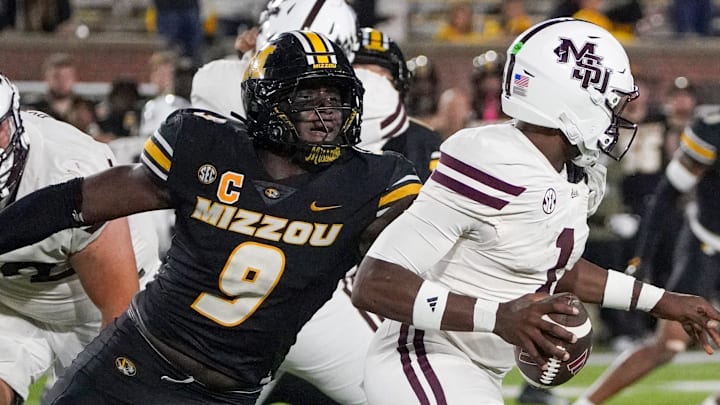 Nov 15, 2025; Columbia, Missouri, USA; Mississippi State Bulldogs quarterback Kamario Taylor (1) runs the ball as Missouri Tigers defensive end Zion Young (9) attempts the sack during the second half of the game at Faurot Field at Memorial Stadium. Mandatory Credit: Denny Medley-Imagn Images