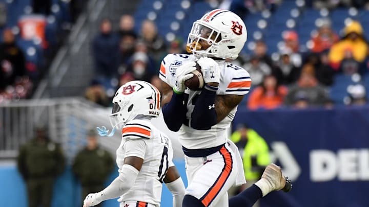 Auburn Tigers safety Caleb Wooden intercepts a pass during the Music City Bowl against the Maryland Terrapins at Nissan Stadium in Nashville, Tenn., on Dec. 23, 2023. Wooden returned the pick 15 yards and also had three tackles, one for a Maryland loss.