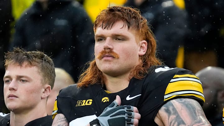 Iowa Hawkeyes offensive lineman Gennings Dunker (67), center, stands with teammates for the national anthem Iowa Hawkeyes offensive lineman Gennings Dunker (67), center, stands with teammates for the national anthem