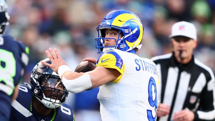 Jan 25, 2026; Seattle, WA, USA; Los Angeles Rams quarterback Matthew Stafford (9) passes against Seattle Seahawks defensive end DeMarcus Lawrence (0) during the first half in the 2026 NFC Championship Game at Lumen Field. Mandatory Credit: Kevin Ng-Imagn Images