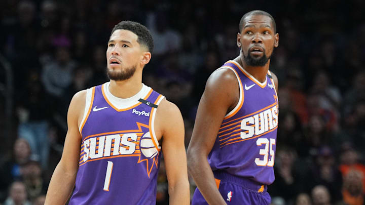 Nov 27, 2024; Phoenix, Arizona, USA; Phoenix Suns guard Devin Booker (1) and Phoenix Suns forward Kevin Durant (35) look on against the Brooklyn Nets during the first half at Footprint Center. Mandatory Credit: Joe Camporeale-Imagn Images