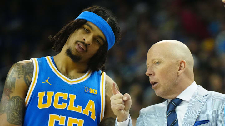 Mar 8, 2025; Los Angeles, California, USA; UCLA Bruins head coach Mick Cronin (center) talks with guard Skyy Clark (55) and guard Lazar Stefanovic (10) in the second half against the Southern California Trojans at Pauley Pavilion presented by Wescom. Mandatory Credit: Kirby Lee-Imagn Images