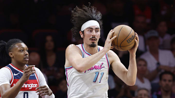 Apr 13, 2025; Miami, Florida, USA; Miami Heat guard Jaime Jaquez Jr. (11) passes in front of Washington Wizards guard Bub Carrington (8) during the first half at Kaseya Center. Mandatory Credit: Rhona Wise-Imagn Images