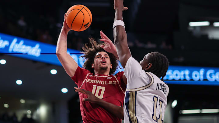 Feb 28, 2026; Atlanta, Georgia, USA; Florida State Seminoles guard Lajae Jones (10) attempts to dunk on Georgia Tech Yellow Jackets forward Baye Ndongo (11) in the first half at McCamish Pavilion. Mandatory Credit: Brett Davis-Imagn Images
