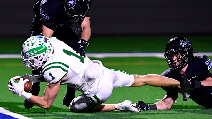 Wall wide receiver Reid Robertson falls into the end zone with the ball for a touchdown despite the efforts of Gunter defensive back Parker Aleman (center) and linebacker Blake Boland during Friday’s Region I-4A DI football semifinal in Stephenville Dec. 12, 2025. Final score was 28-25, Wall will face Newton In the UIL 3A Division II Championship Game on Thurs. Dec. 18 2025  at AT&T Stadium in Dallas, TX.